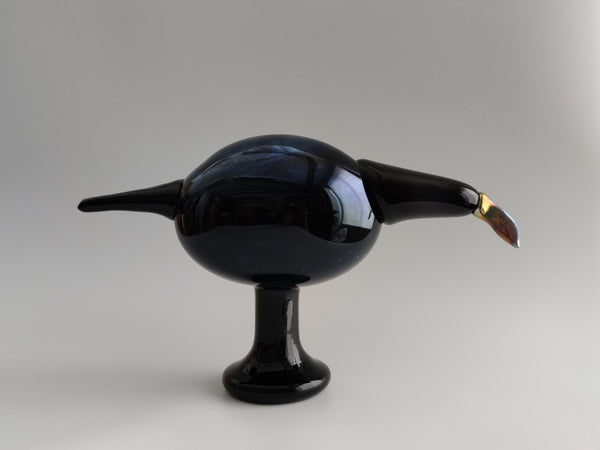 Glossy black bird-shaped object on a gray background