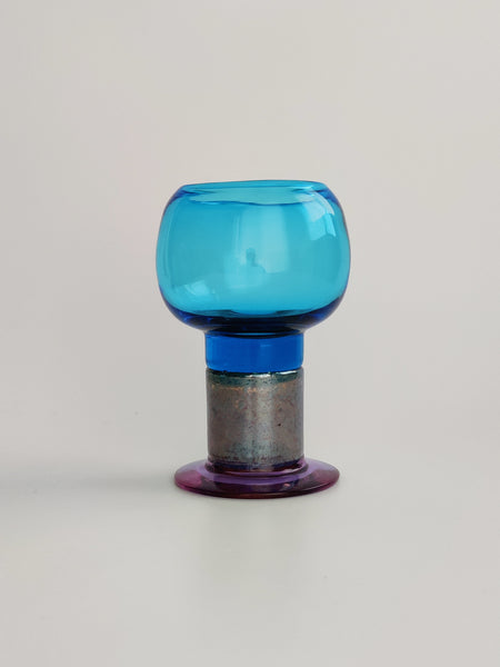 Light blue glass trophy with luster base on a light gray background